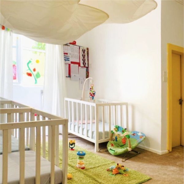 Bright nursery with cots and toys