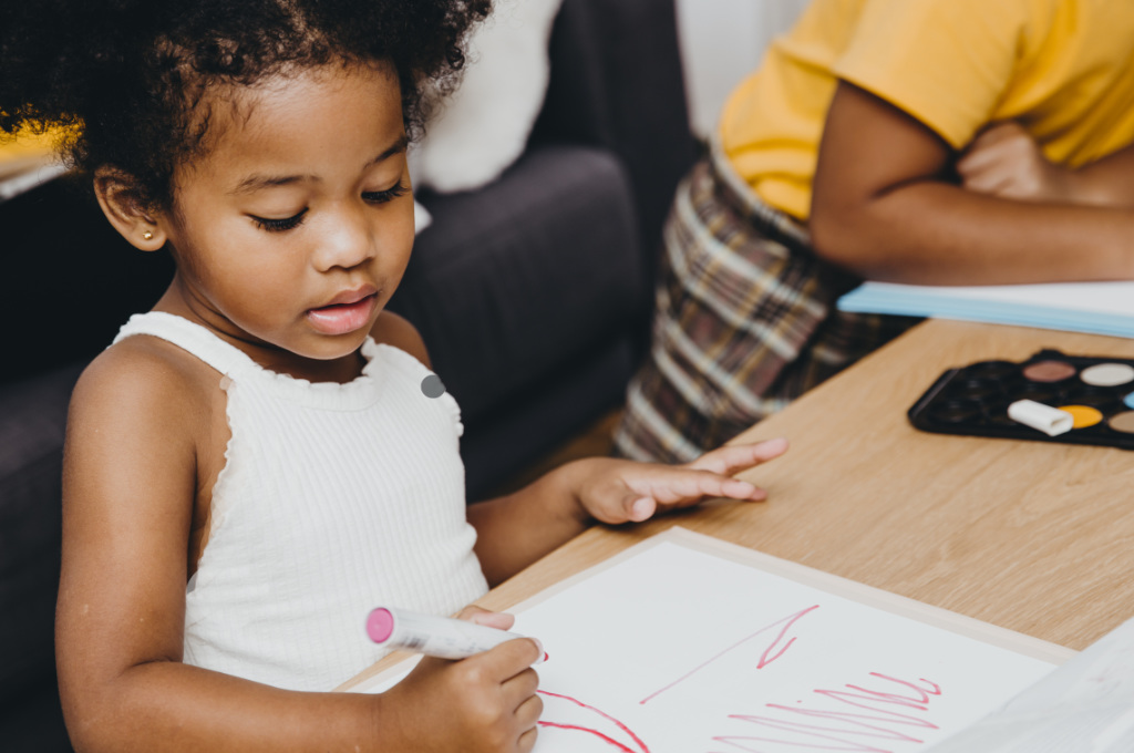 Young girl drawing a picture at Daycare