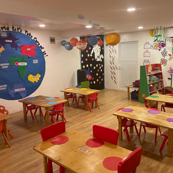 activity room with small groups of colour coded tables and chairs